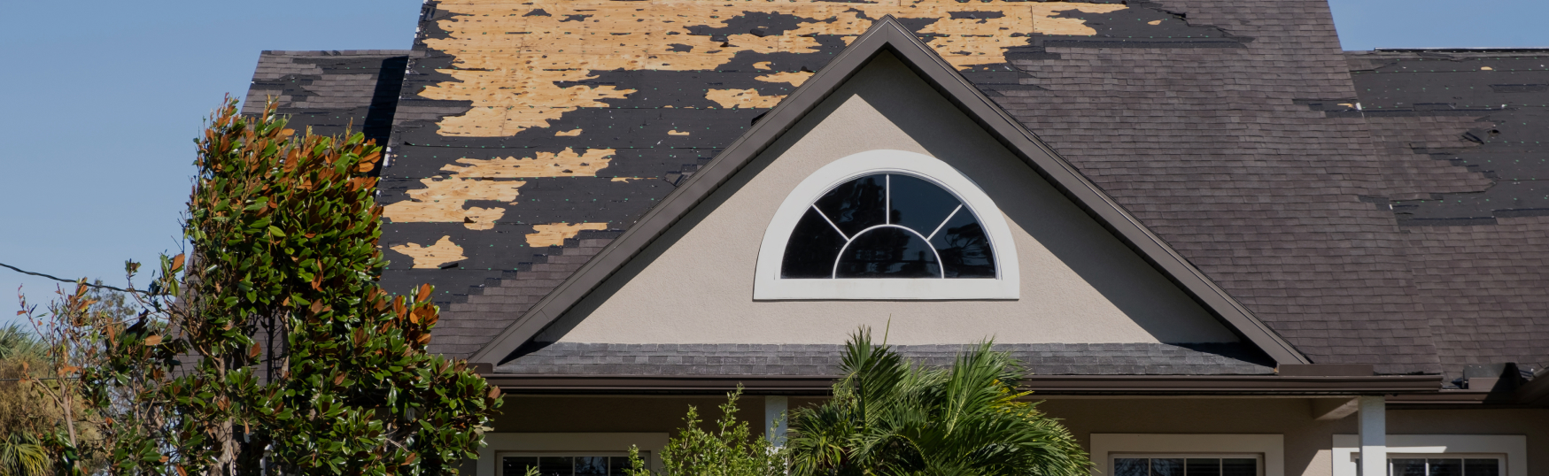 White accordion hurricane shutters for windows on Florida home, exterior storm shutters fully deployed